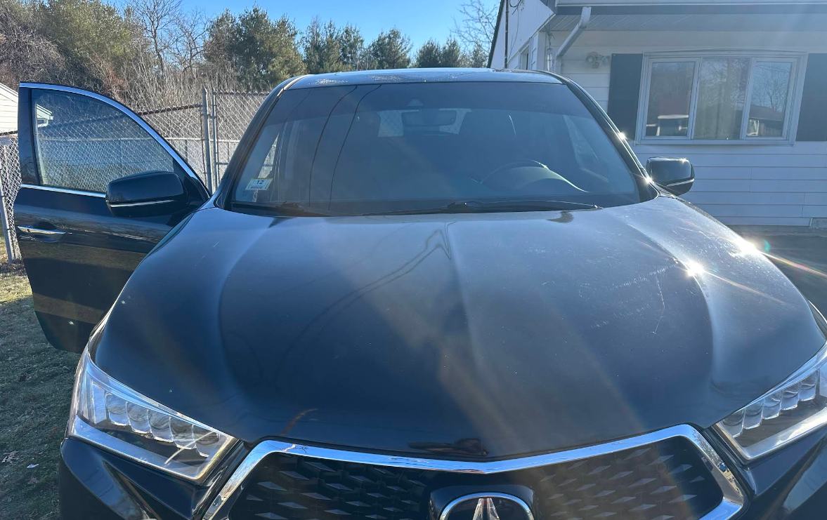 Black Acura with tinted windshield